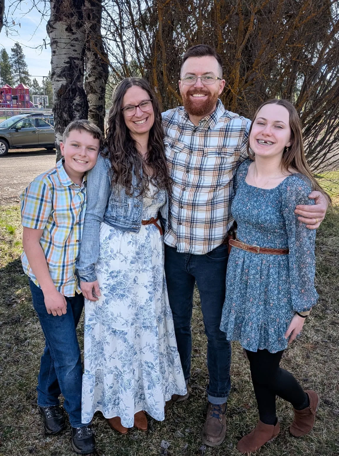 Members of the Cohrac family standing together outside a camp building