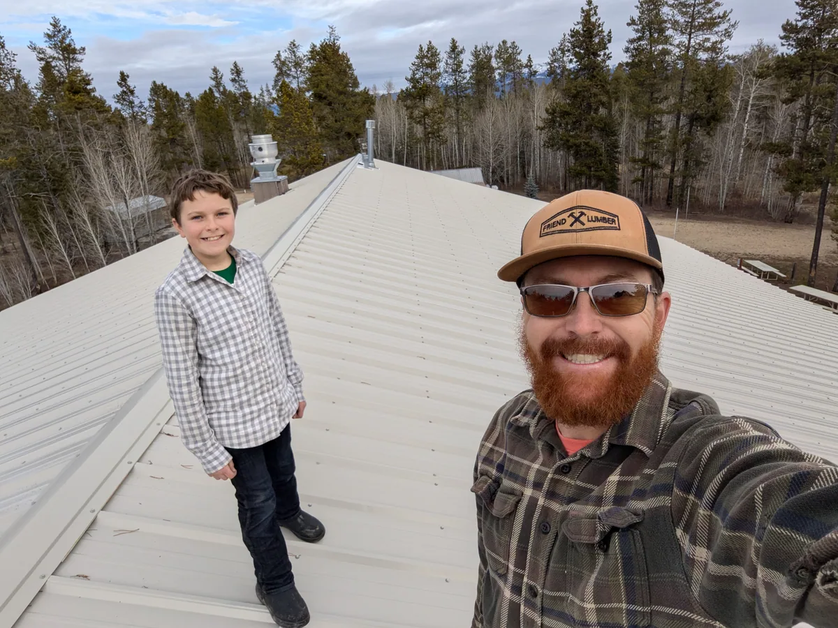 Chase and his son on a roof during a maintenance project